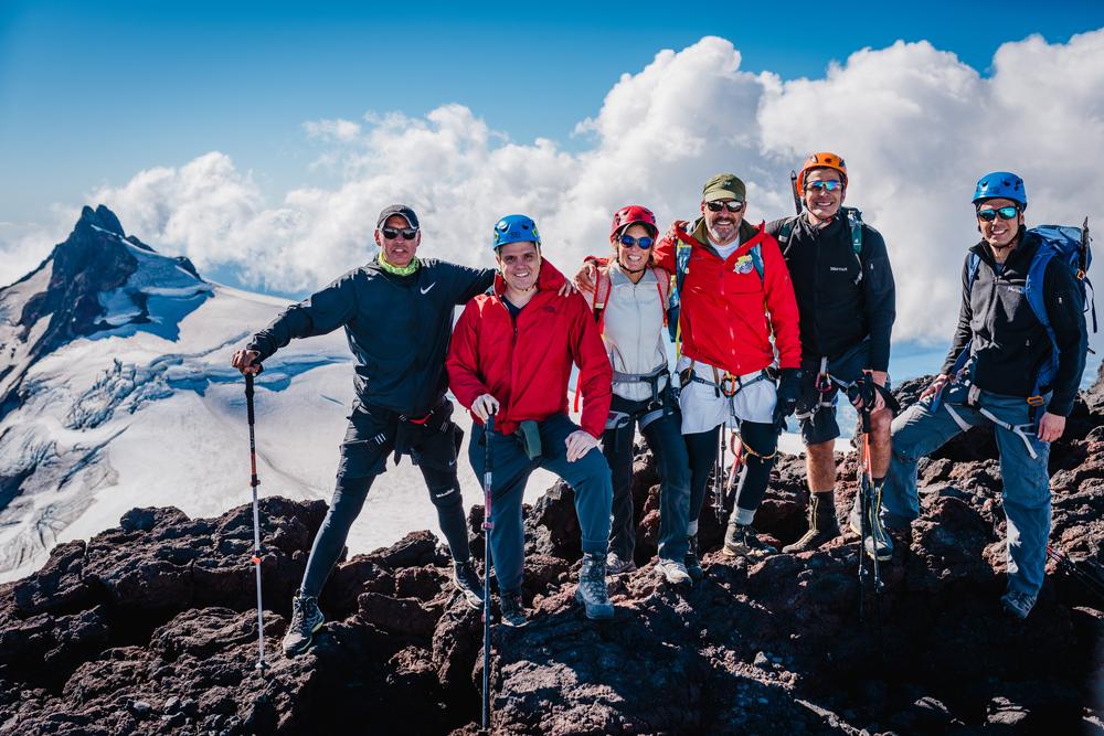 Grupo en la cumbre con el pico Choshuenco y el glaciar detrás